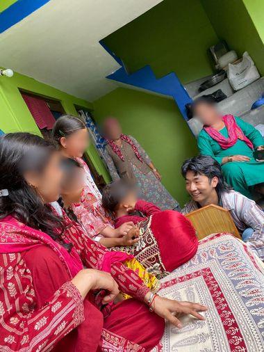 Ian sitting with a South Asian family overseas on the mission field